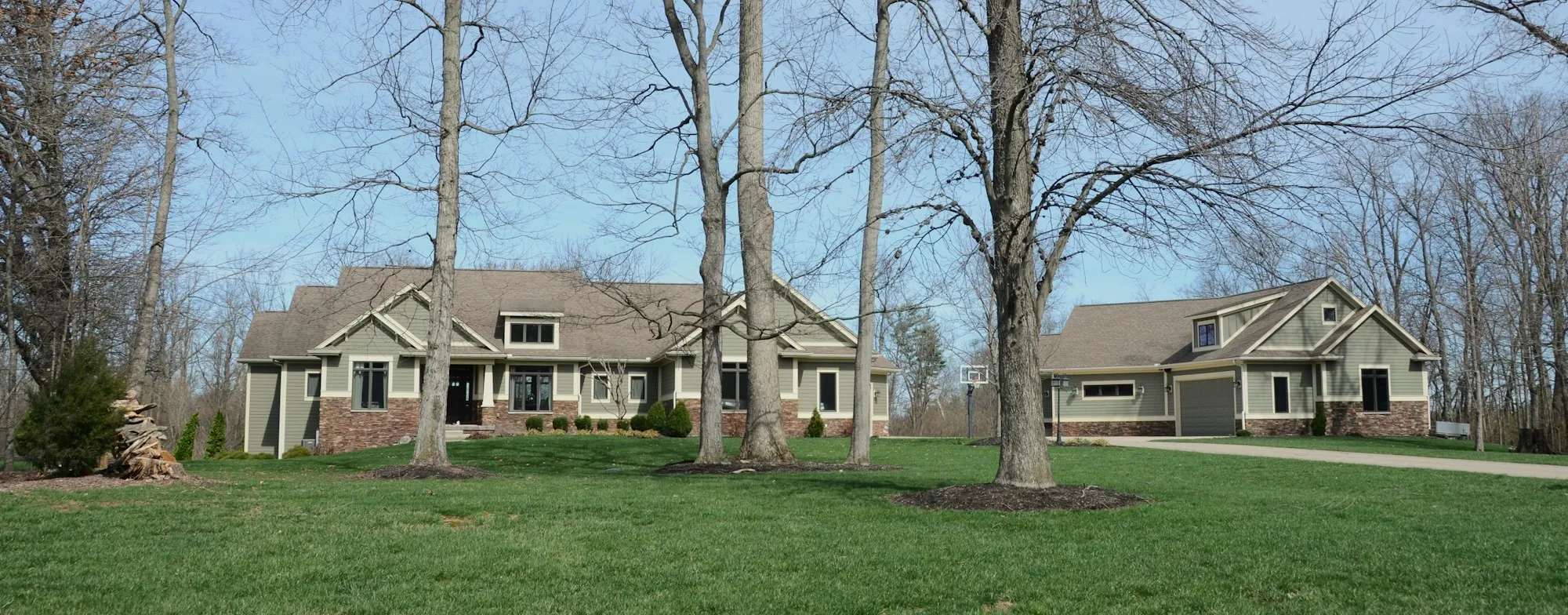 Tree-lined street of older two-story homes with front porches