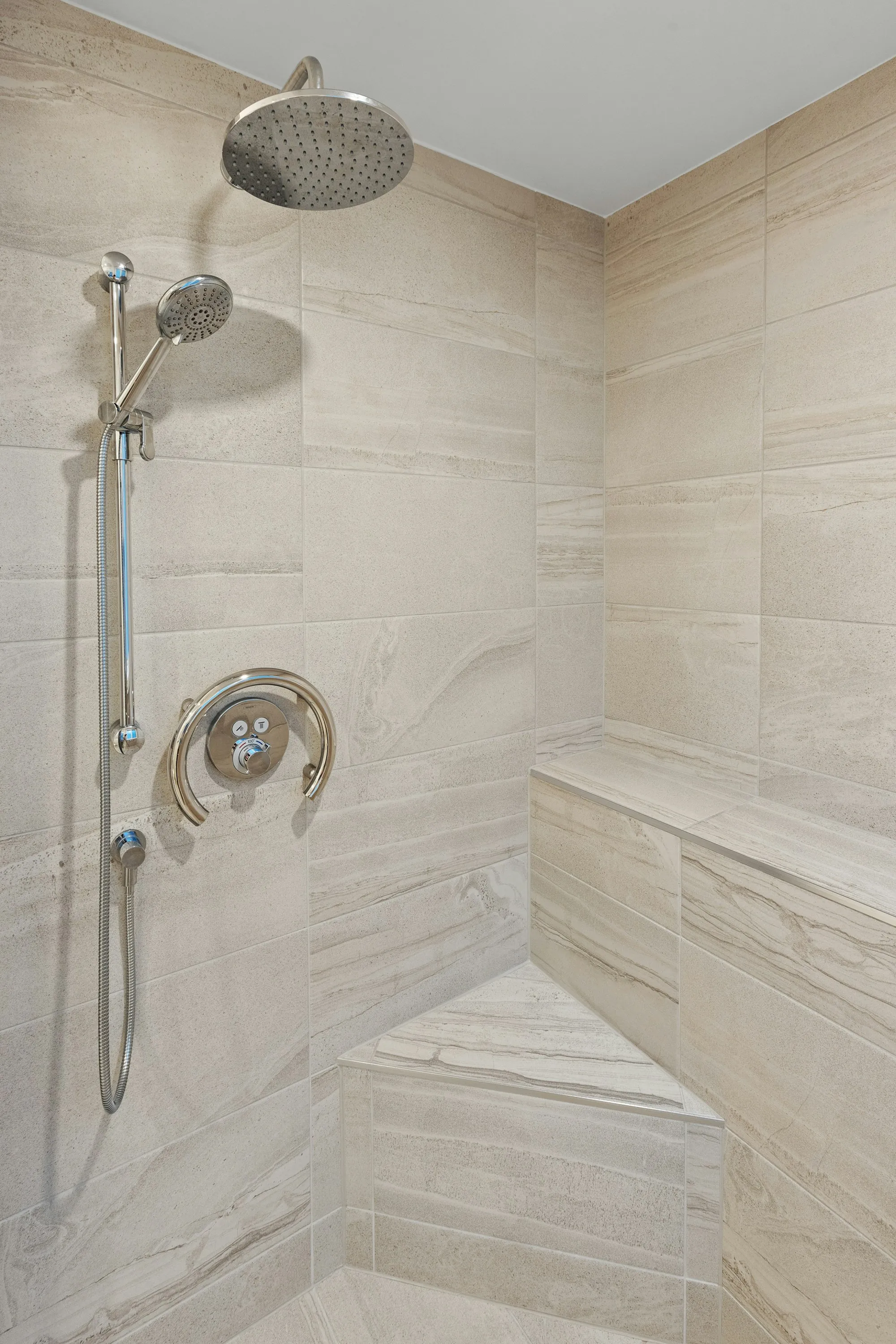 New tiled shower with a recessed niche and glass door