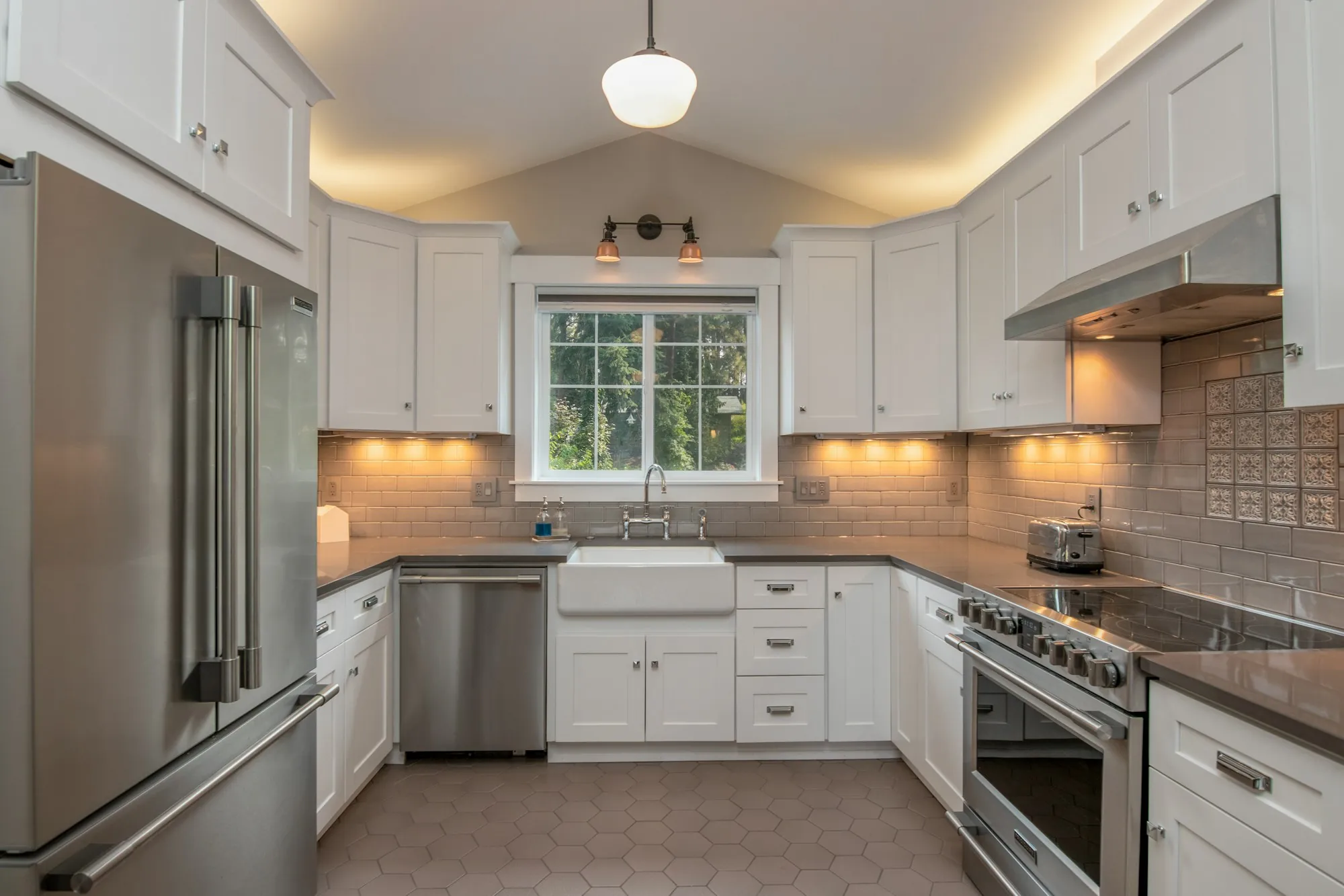 Tile, paint and cabinet samples laid out on a kitchen counter
